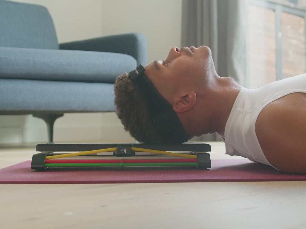 NecksLevel Glide in use doing chin tucks on mat